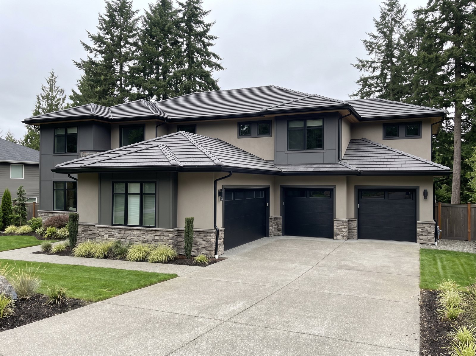 Charcoal flat-profile concrete tile roof on a contemporary Greater Seattle home, seen from the driveway