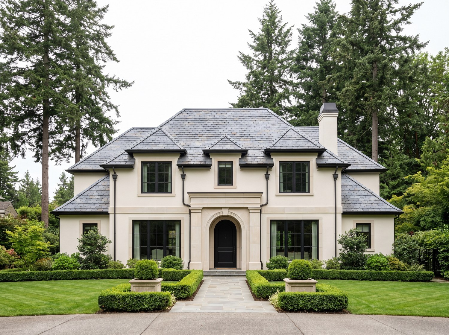 Natural blue-gray slate roof on a limestone estate home in Greater Seattle, seen from the driveway